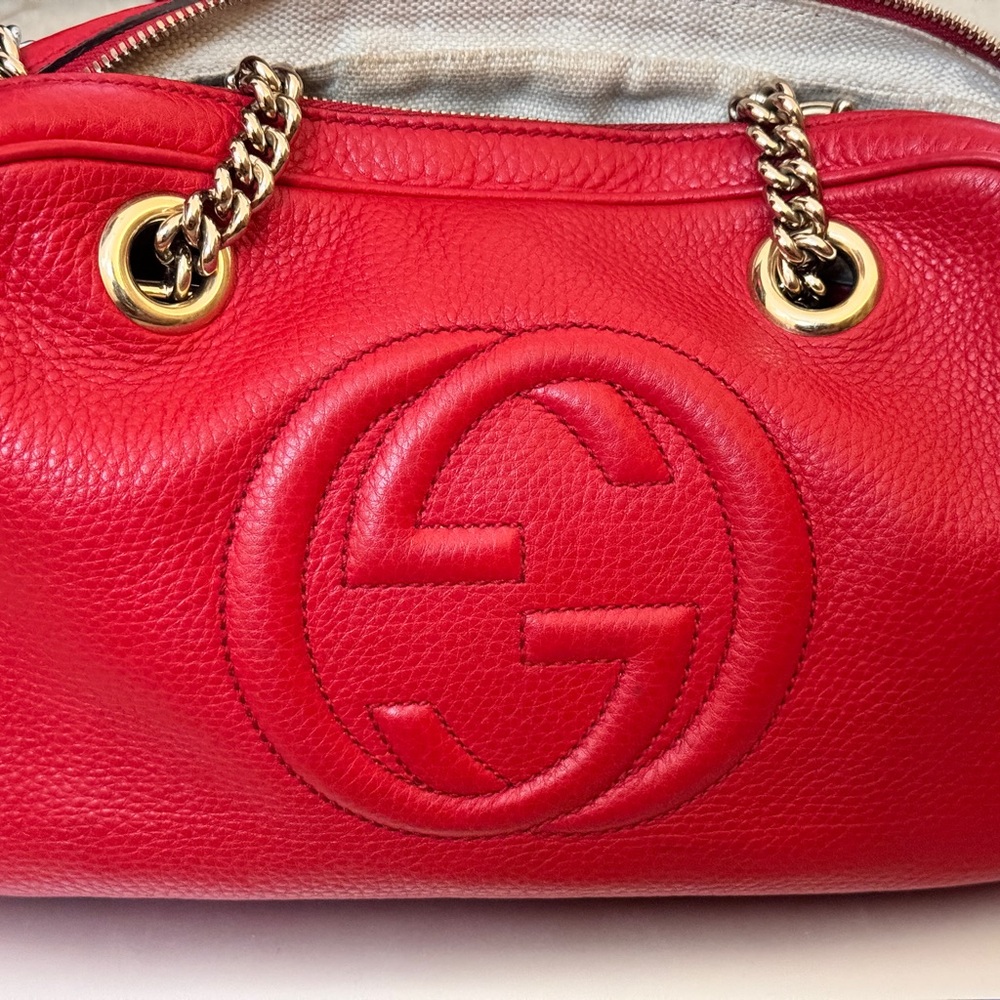 Red. Medium size Gucci bag w/tassel. Good condition